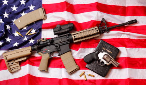 Rifle, revolver and bible on flag
