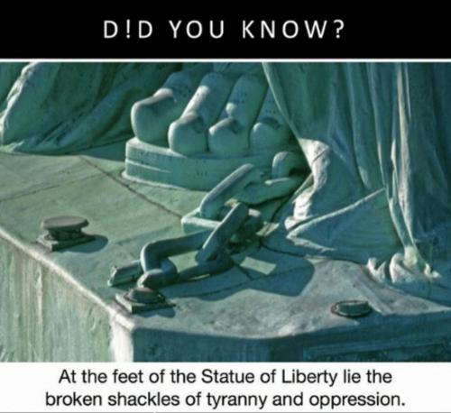 at the feet of the statue of liberty