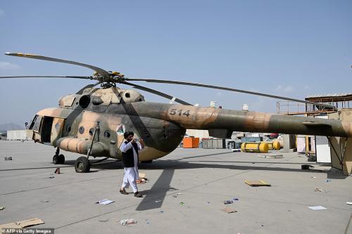 47318623-9942593-A_Russian_Mi_17_helicopter_is_pictured_alongside_Taliban_fighter-a-67_1630434645493
