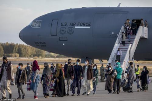 47321523-9942593-Afghan_evacuees_disembark_from_US_Air_Force_plane_at_Rota_Naval_-a-90_1630436646847