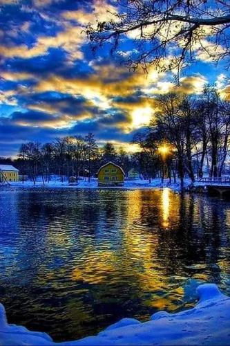 Blue sunrise on snowy lake