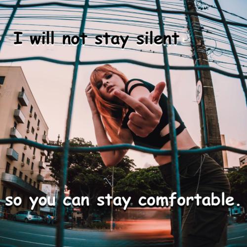 I will not stay silent so you can stay comfortable - Woman flipping off camera behind fence - eduarda portrait 2527716 Pexels