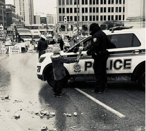 Protestor's child in Ottawa offers police officer a bouquet of flowers