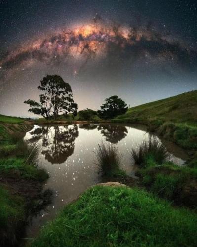 Milky way view from hilltop lake