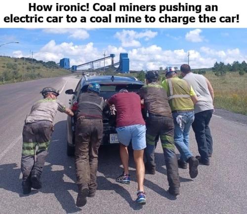 Coal miners pushing an electric car to a coal mine to recharge