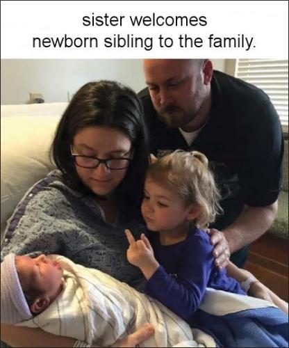 sister welcomes newborn sibling to the family