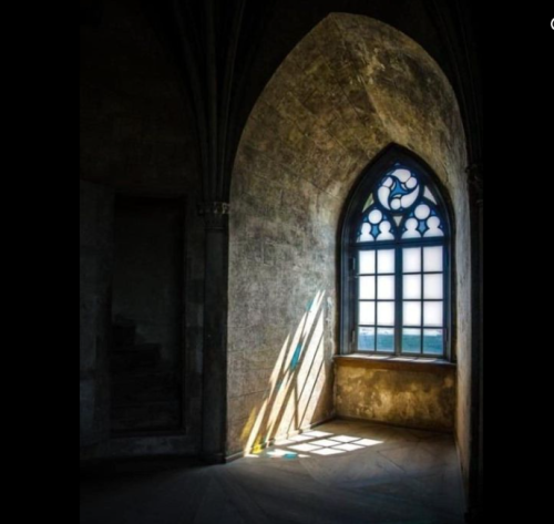Light in dark church attic