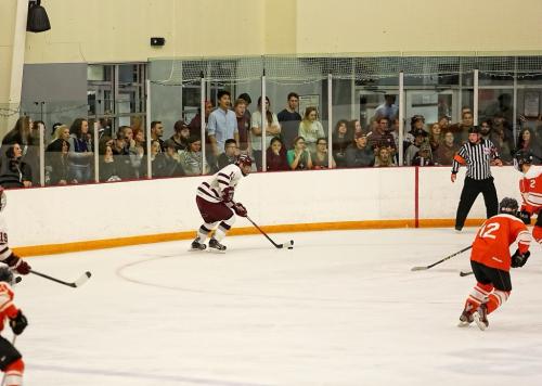 Carrying the puck in, looking to pass