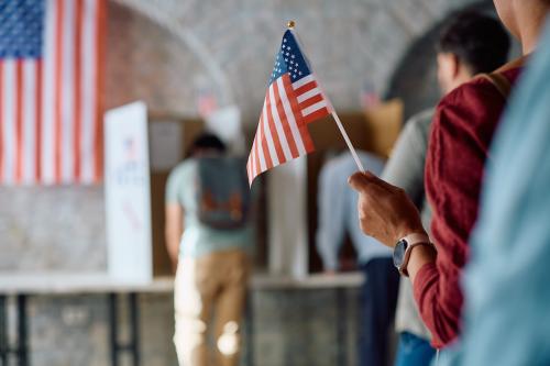 close-up-of-black-woman-holding-us-flag-while-wait-2024-12-13-18-19-45-utc
