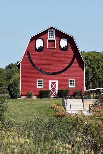 70306330-Smiley-face-barn-beside-rural-home-in-Southern-Wisconsin