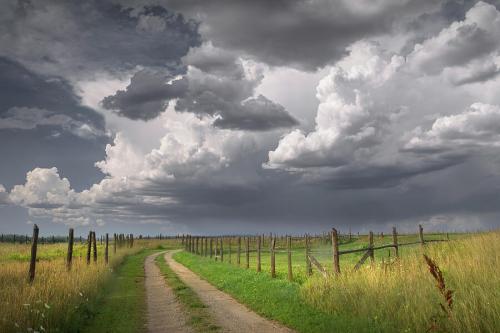 country-road-under-dramatic-clouds-randall-nyhof