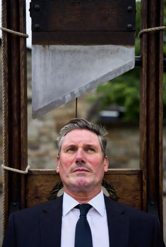 keir starmer laying on a guillotine